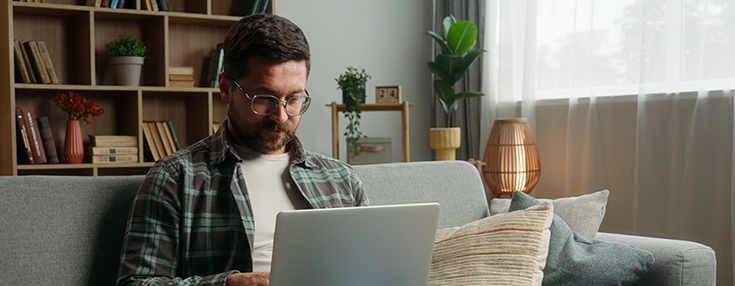 man with laptop sofa