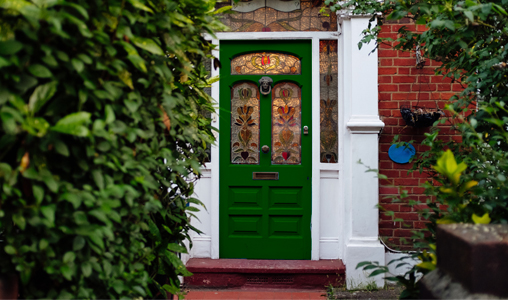 Brick house with green Victorian front door